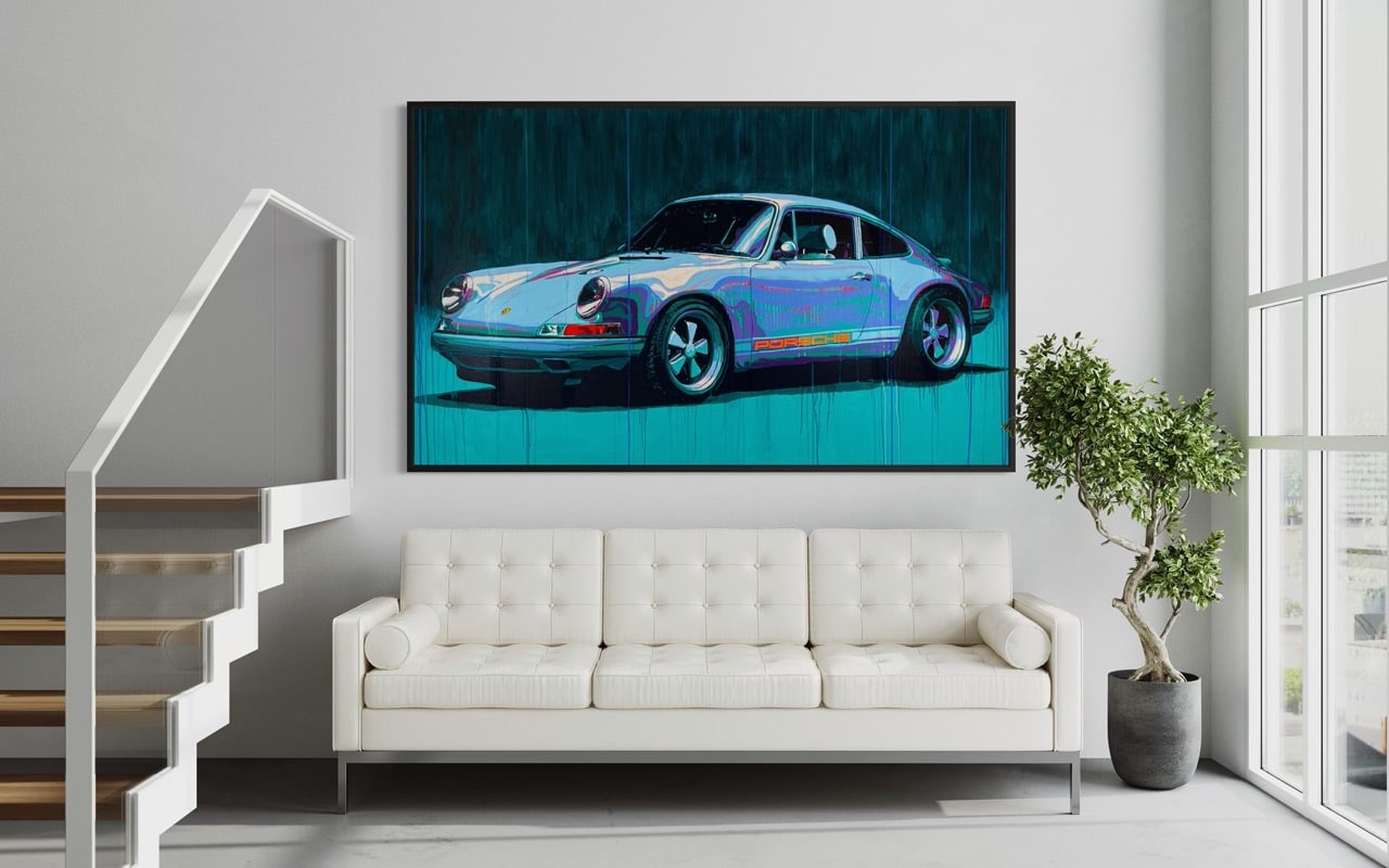 Modern living room with a white tufted sofa beneath a large framed painting of a blue Porsche car, bright natural light from floor-to-ceiling windows, and a potted plant nearby.